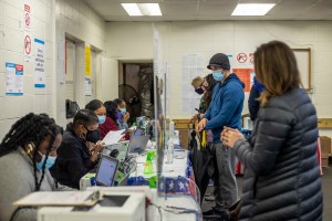 Fulton County elections workers work with voters during early voting in the state's runoff election at Chastain Park Gymnasium in Atlanta's Chastain Park neighborhood, Wednesday, Dec. 16, 2020.