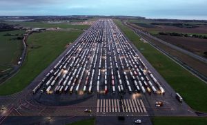 An aerial view shows lines of freight lorries and heavy goods vehicles parked on the tarmac at Manston Airport in Kent after France closed its borders with the UK due to a new COVID variant. Photo: WILLIAM EDWARDS/AFP via Getty Images