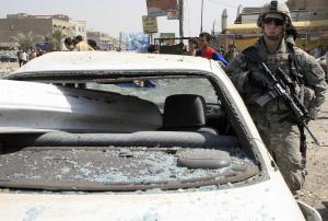 A US soldier stands guard at the site of a car bomb attack in Baghdad on the day of the massacre. Photo: WISSAM AL-OKAILI/AFP via Getty Images