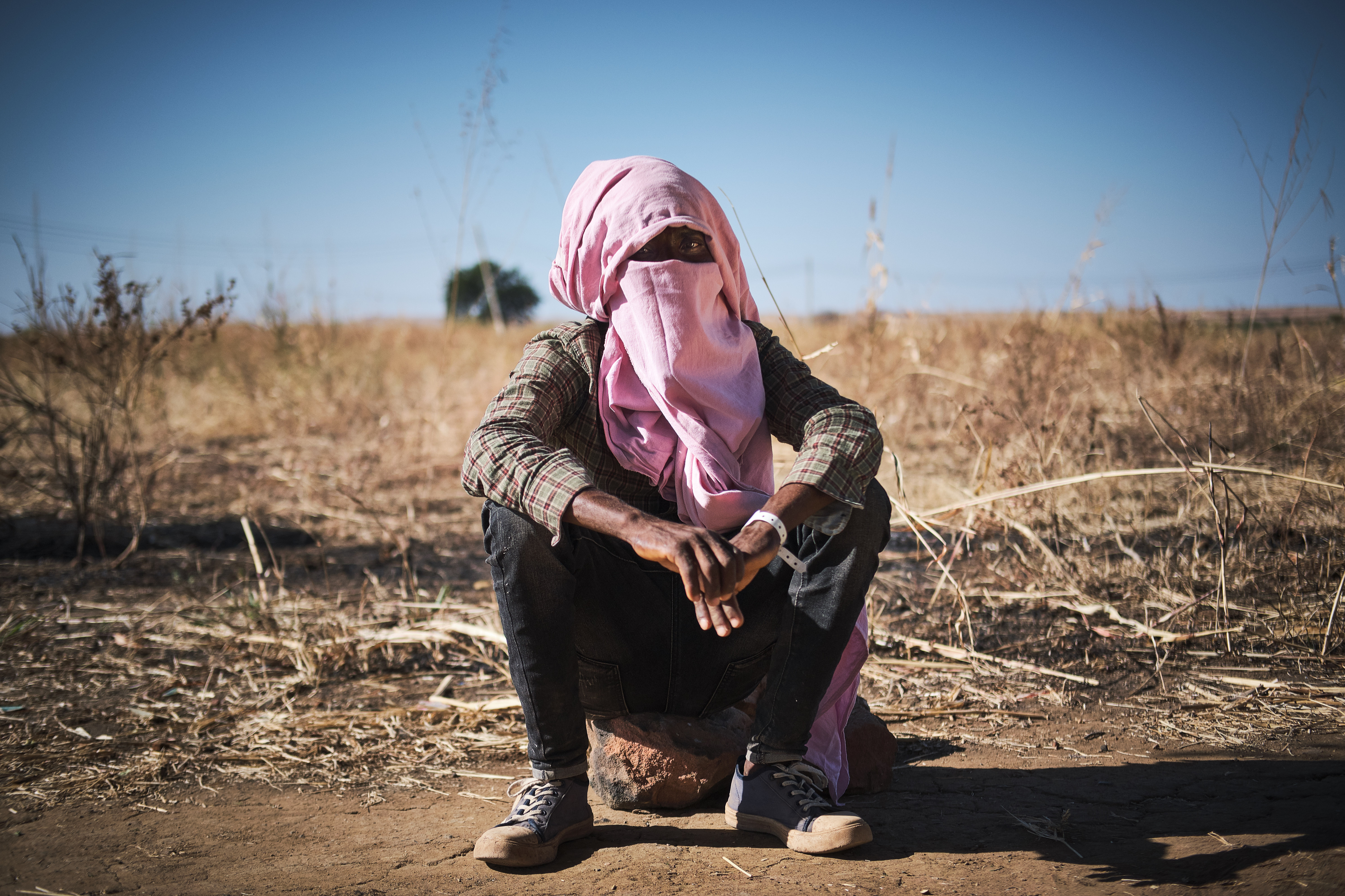 A man who said he was forcibly recruited by the TPLF waits in Um rukuba refugee camp.