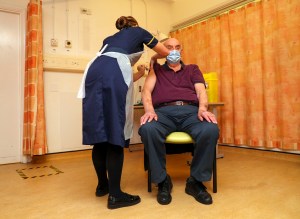 82-year-old Brian Pinker receives the Oxford University/AstraZeneca COVID-19 vaccine from nurse Sam Foster at the Churchill Hospital in Oxford​.