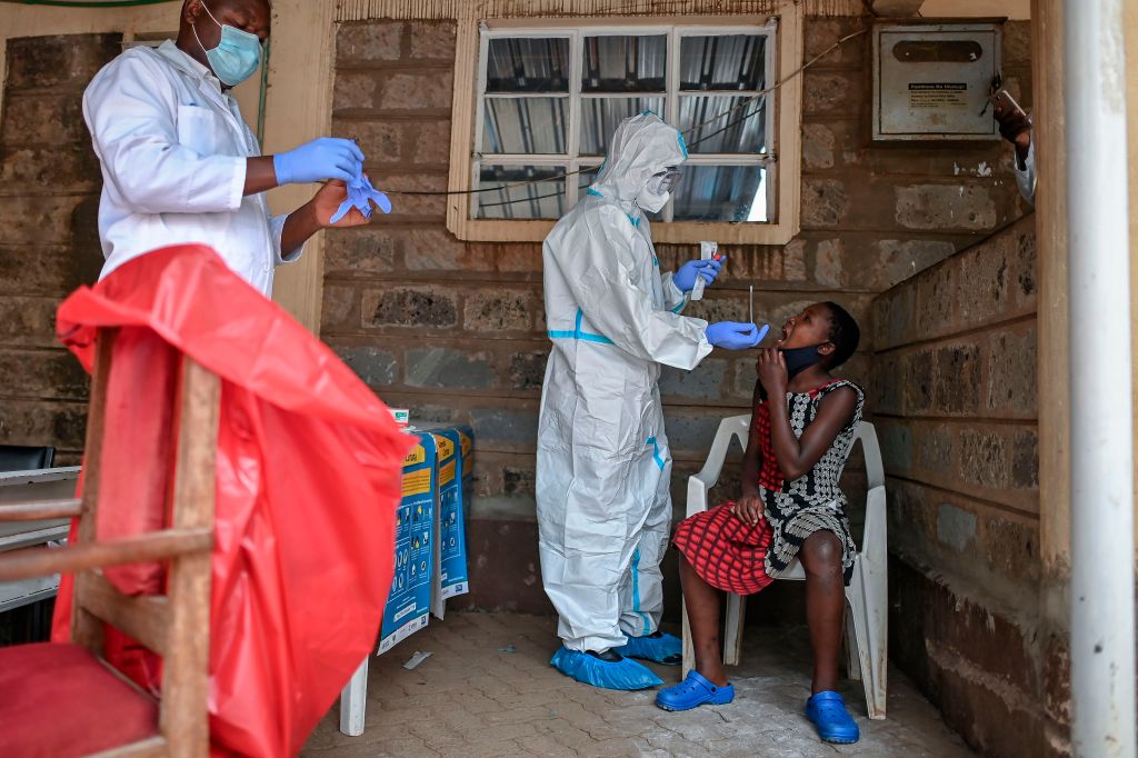 A young girl waits to be tested during a mass testing for COVID-19 coronavirus provided free of charge by the Kenyan government in the Kibera slum in Nairobi