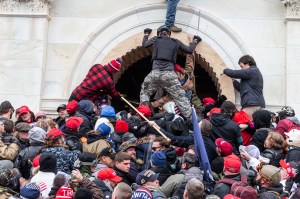 Rioters clash with police trying to enter Capitol building through the front doors in Washington, DC on January 6, 2021. Rioters broke windows and breached the Capitol building in an attempt to overthrow the results of the 2020 election.