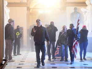 A Trump supporter holding a cell phone at the January 6 riots on Capitol Hill.