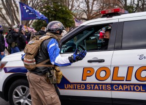 A protester argues with a Capitol Hill policeman as crowds gather outside the U.S. Capitol for the "Stop the Steal" rally on January 06, 2021 in Washington, DC.