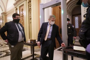 Rep. Jim Jordan, R-Ohio, an ally of President Donald Trump, passes through a metal detector as he enters the House chamber, new security measures put into place after a mob loyal to Trump stormed the Capitol, in Washington, Tuesday, Jan. 12, 2021. (AP Pho