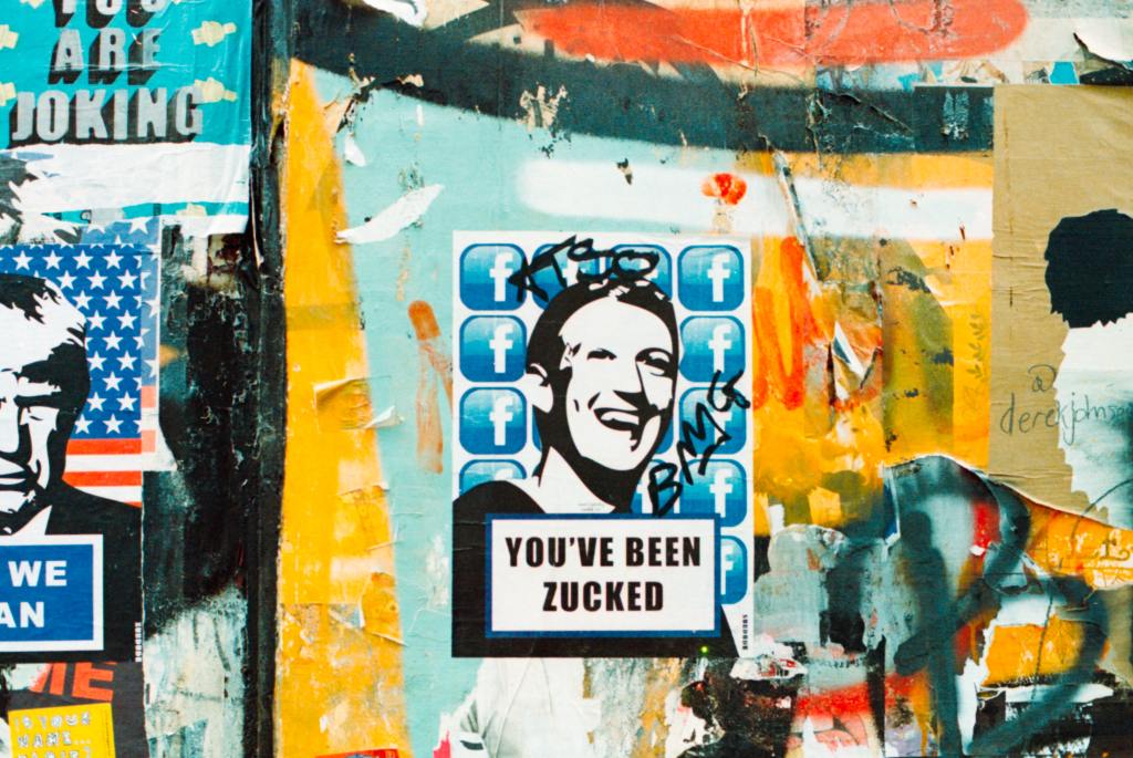 graffiti of Mark Zuckerberg smiling with the words