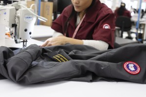 An employee sews a zipper onto a jacket at the new Canada Goose Inc. manufacturing facility in Montreal, Quebec, Canada, on Monday, April 29, 2019.