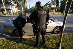 Members of the RCMP Gang Enforcement Team speaks to the occupants of a car during a stop in Surrey, B.C., Friday, May 31, 2019.