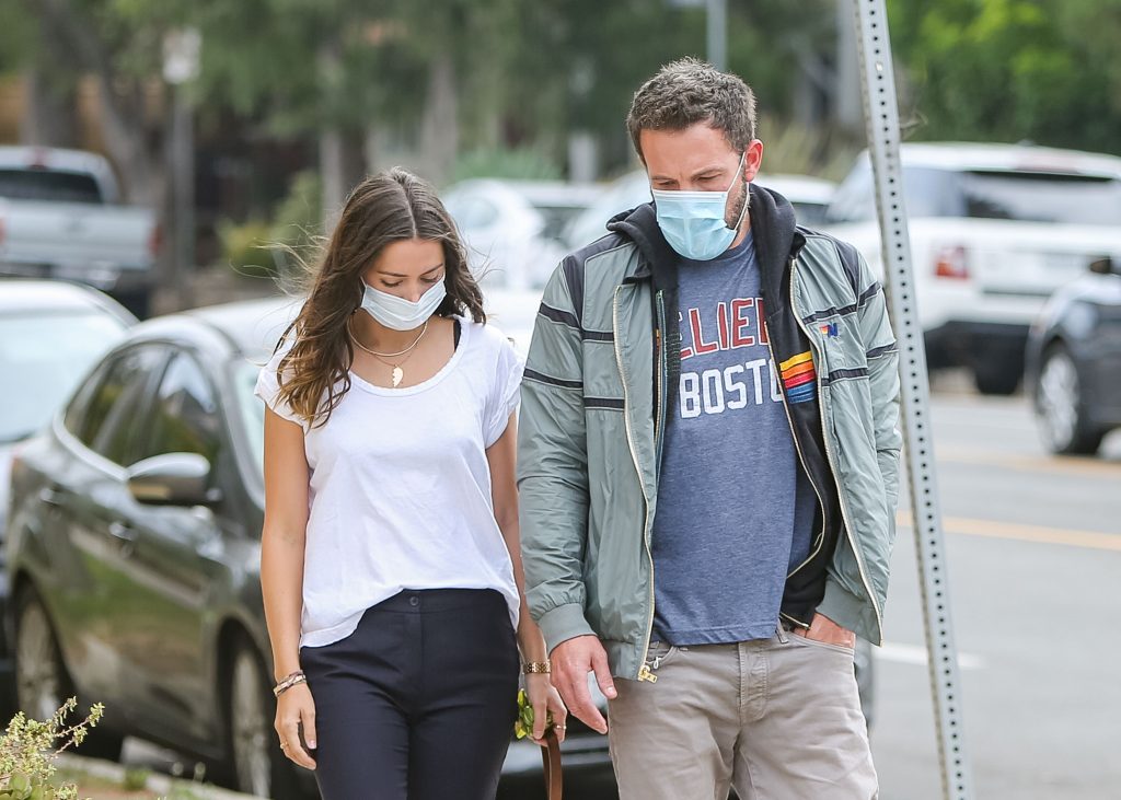 paparazzi photo of ben affleck and ana de armas going for a walk while wearing blue surgical masks