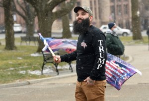 Lone Trump supporter Mark Leggiero, of Florida, N.Y., stands outside the New York state Capitol objecting the inauguration of President Joe Biden, Wednesday, Jan. 20, 2021, in Albany, N.Y.(AP Photo/Hans Pennink)​