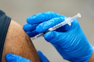 FILE - In this Jan. 5, 2021, file photo, healthcare worker receives a second Pfizer-BioNTech COVID-19 vaccine shot at Beaumont Health in Southfield, Mich.