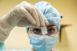 A lab technician prepares a coronavirus vaccine