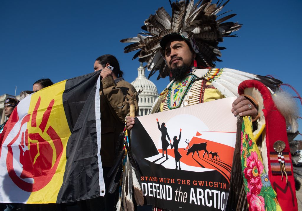 Indigenous leaders hold signs against drilling in the Arctic Refuge during a press conference outside the US Capitol in Washington, DC, December 11, 2018.