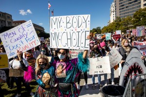 Protesters wearing face masks hold placards during the demonstration. Women's March, a feminist organization, planned a rally and marched to bring opposition against President Donald Trump, and his plans to fill the Supreme Court seat left by Ruth Bader G