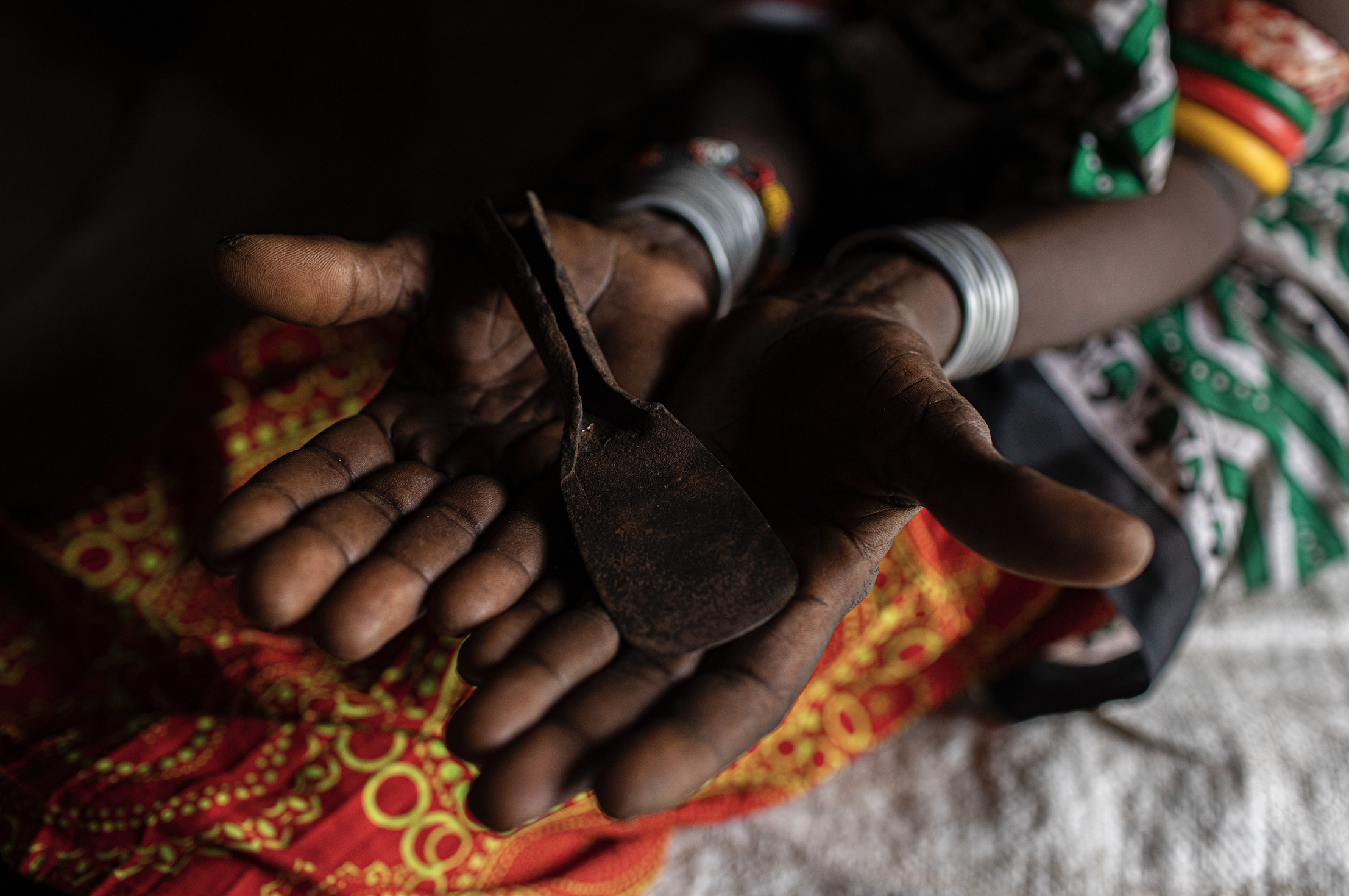 A woman holds a tool in her hand.