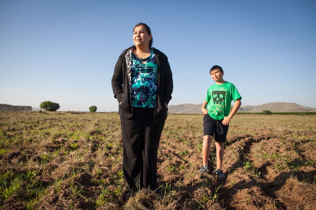 Claudia Ángulo and her son Isaac in Orange Cove, California, where they live​.