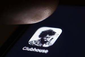 Clubhouse - a user clicking on the app on their smartphone