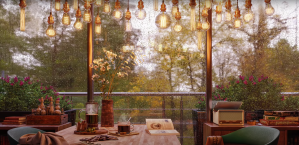 screenshot of a youtube ambience video featuring a cup of coffee and a book on a wooden table in a warmly lit room; it is grey and rainy outside