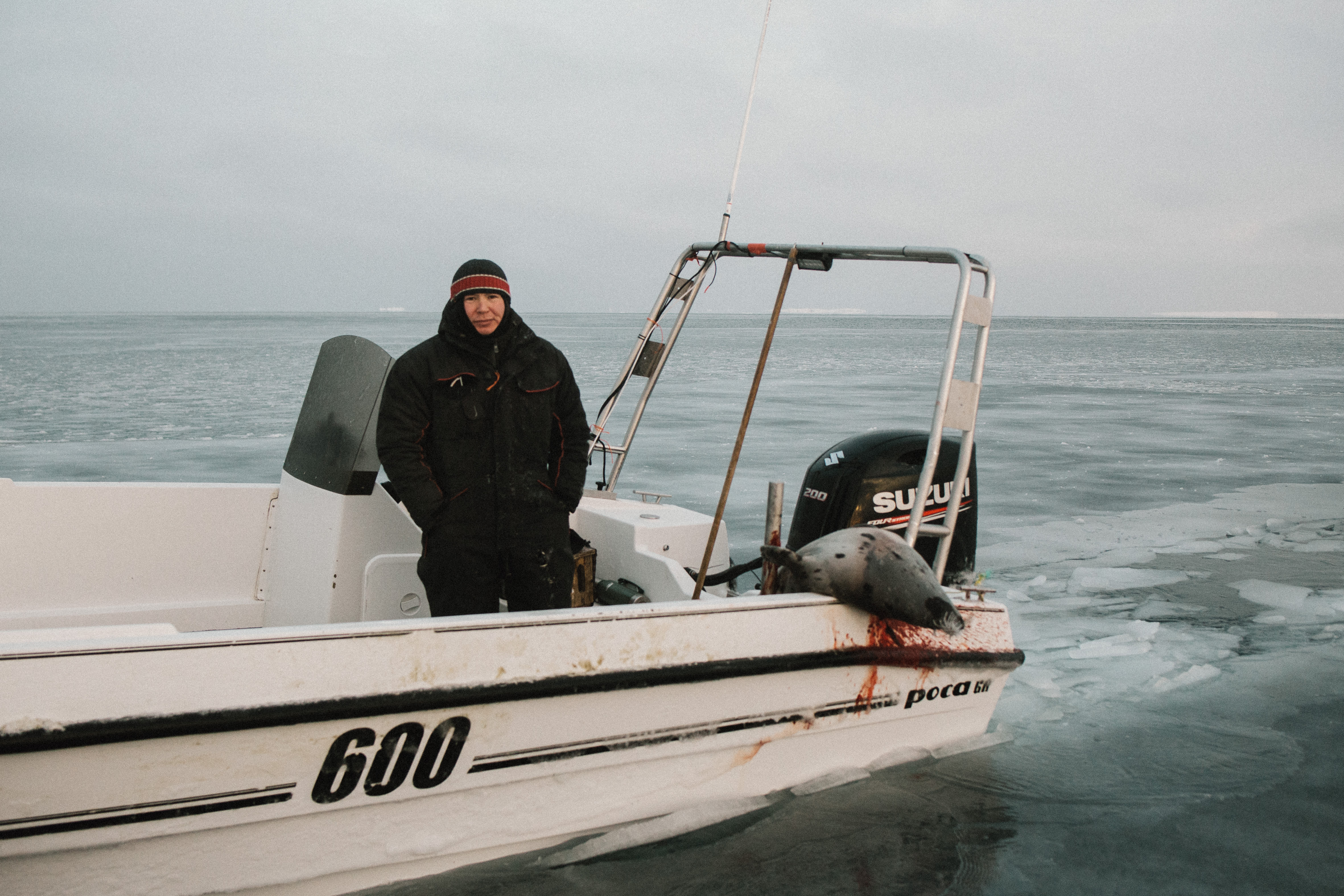 LARS NIELSEN, AN INUK MAN FROM AKUNNAAQ ON A SPEED BOAT