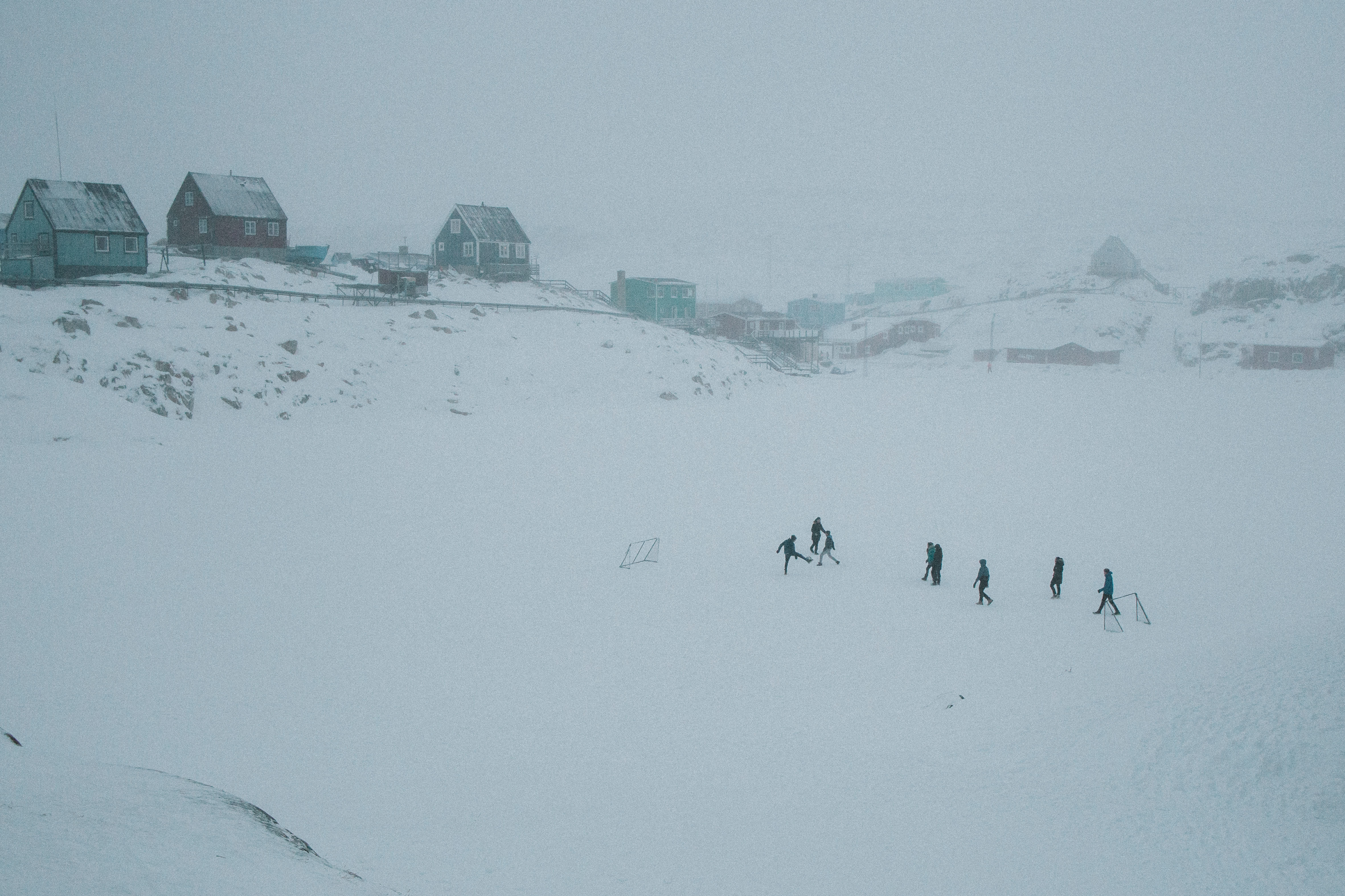 KIDS PLAY FOOTBALL IN THE SNOW IN AKUNNAAQ