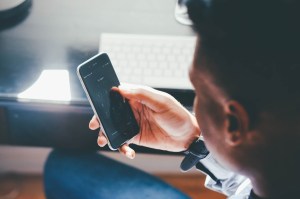 young man checking phone loan apps india