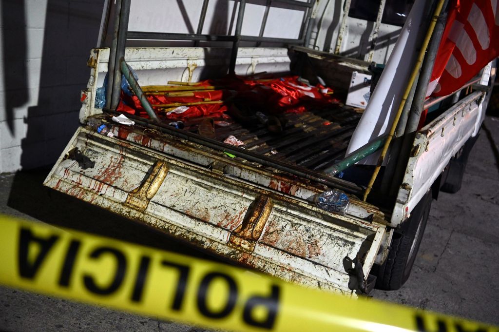 Police guard a truck that carried supporters of the political party Farabundo Marti Front (FMLN), which came under attack when returning from political activity in San Salvador, on January 31, 2021.