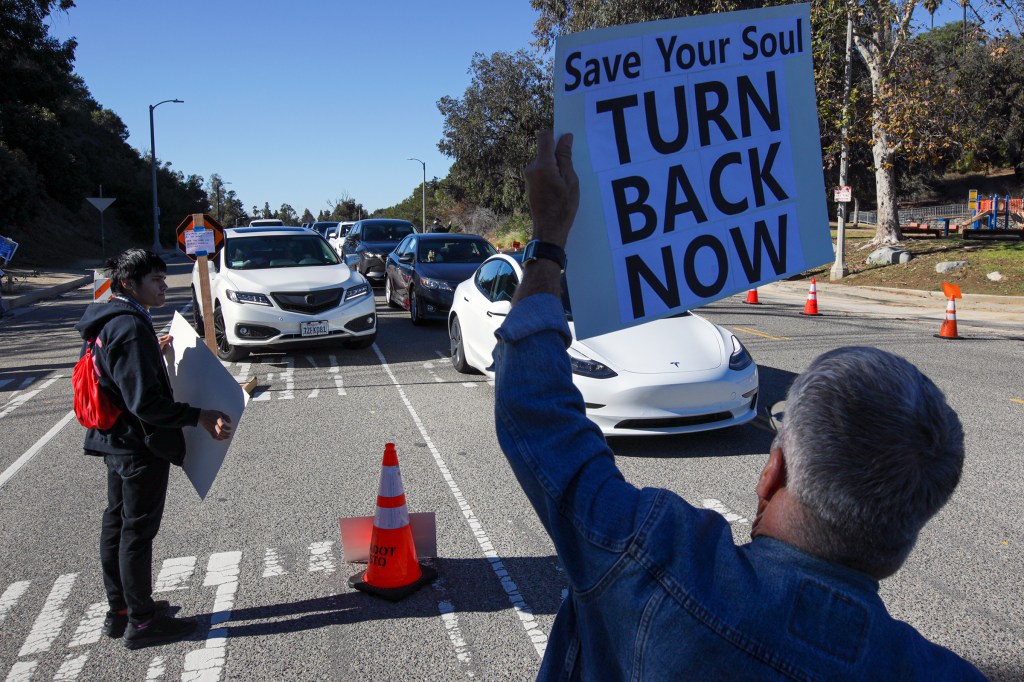 A protest organized by Shop Mask Free Los Angeles rally against COVID vaccine, masks and lockdowns at the vaccination site at Dodger Stadium on Saturday, Jan. 30, 2021 in Los Angeles, California.