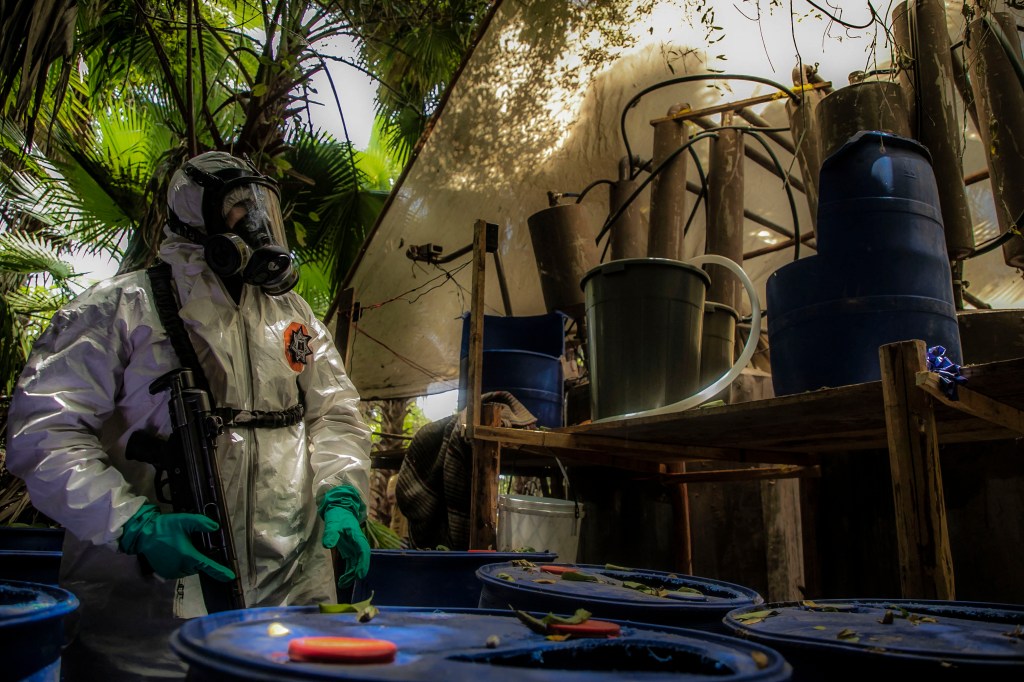 A Sinaloa state police officer looks on as a synthetic​ drug lab is dismantled in June 2019. Photo: RASHIDE FRIAS/AFP via Getty Images