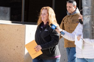 Jenny Cudd, front, a flower shop owner and former Midland mayoral candidate, and Eliel Rosa leave the federal courthouse in Midland, Texas, Wednesday, Jan. 13, 2021.