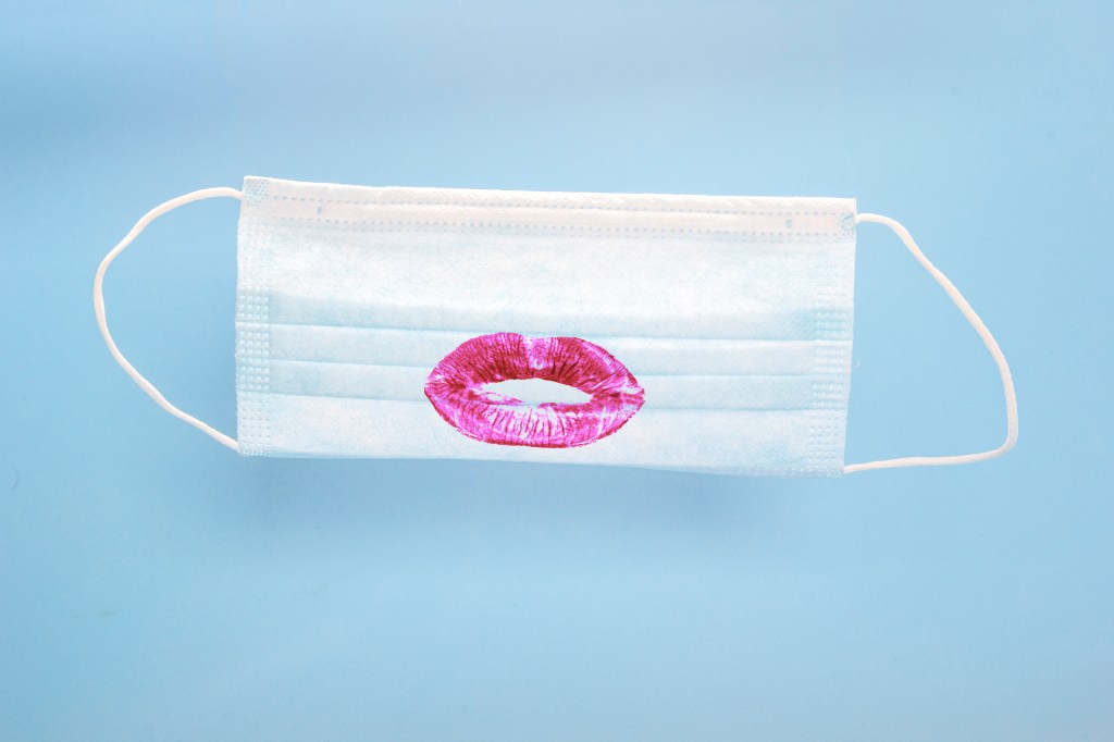 A face mask with a lipstick print on it.