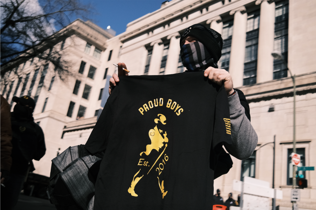 A man holds up for sale a "Proud Boys" T-shirt, referring to the far-right political organization that promotes and engages in political violence, near the state Capitol on January 18, 2021 in Richmond, Virginia.