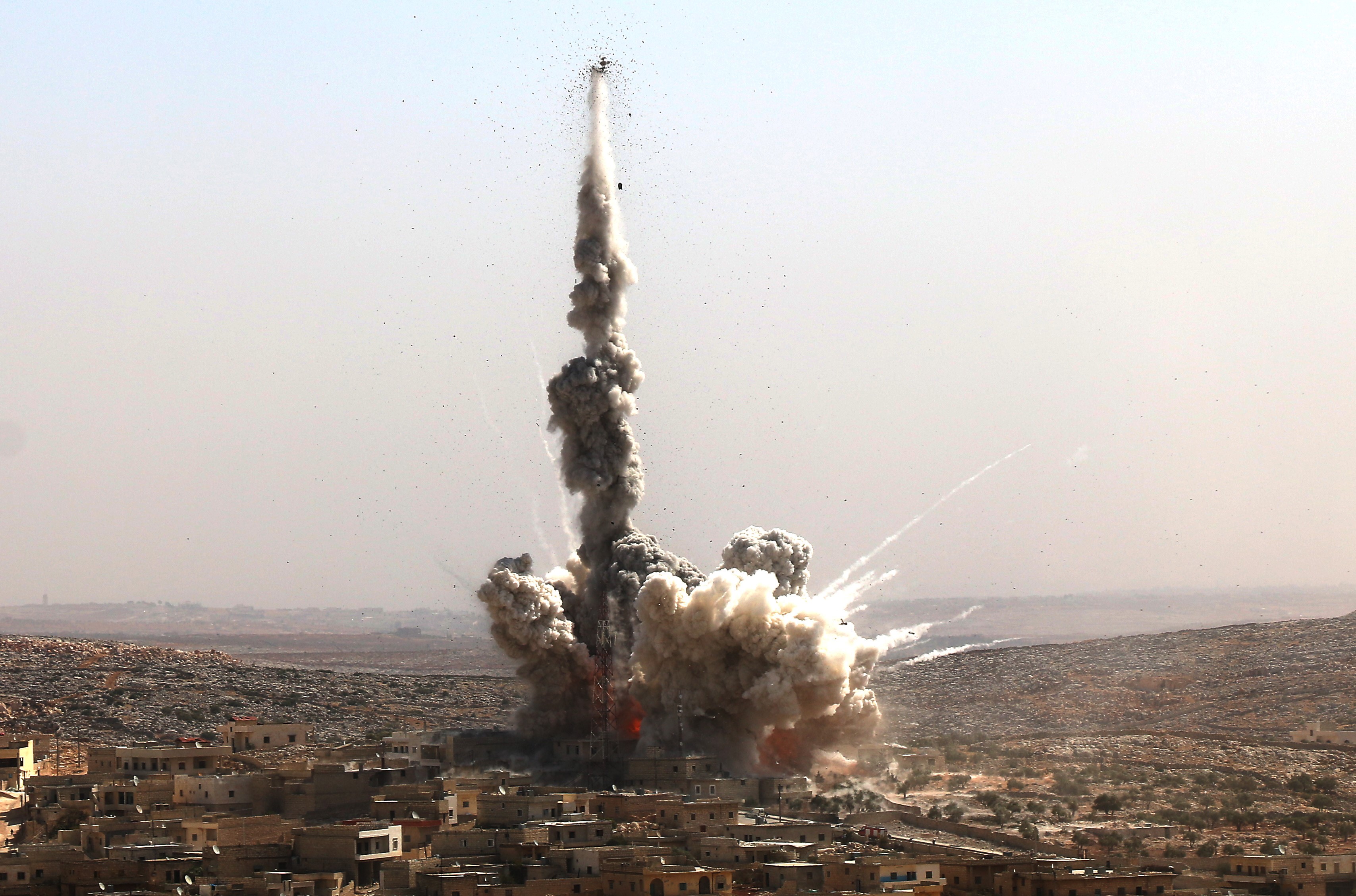 Smoke rises after Syrian and Russian forces bomb a neighbourhood in Aleppo, in 2016.