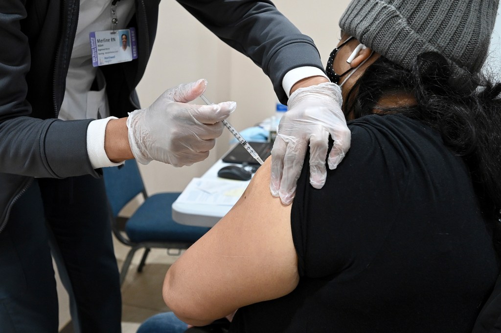 A registered nurse administers a dose of the Pfizer COVID-19 vaccine to a woman at a pop-up vaccination site set up inside United Revival Mennonite Church, in the Brooklyn borough of New York City, NY, February 4, 2021 (Photo by Anthony Behar/Sipa USA)(Si