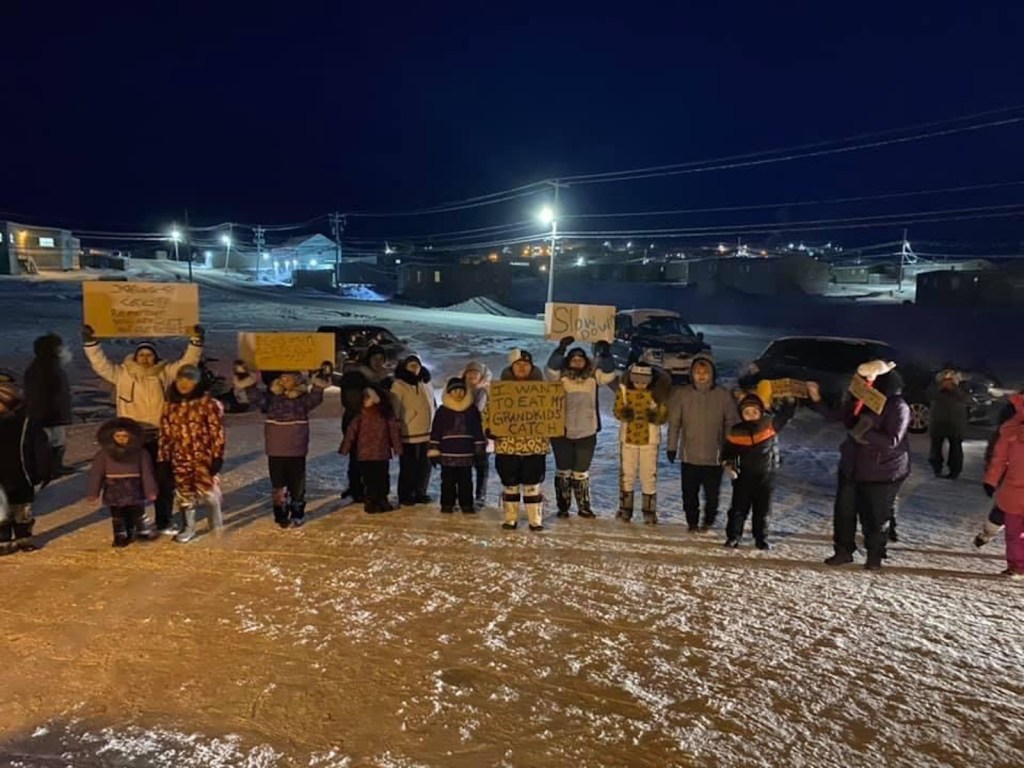 Pond Inlet, Nunavut, residents protest outside the hamlet's community hall where environmental hearings were being held on the expansion of Baffinland's Mary River iron ore mine, in this Friday, Feb. 5, 2021 handout photo.