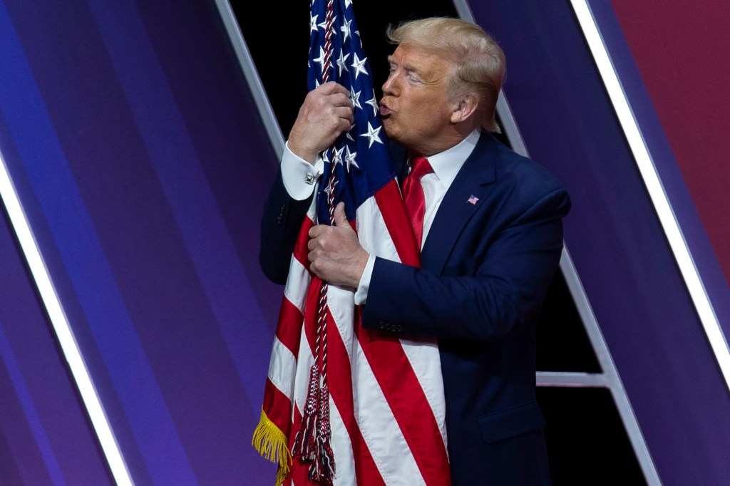 President Donald Trump kisses the American flag after speaking at Conservative Political Action Conference, CPAC 2020, at the National Harbor, in Oxon Hill, Md., Saturday, Feb. 29, 2020.