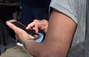 SANTA FE, NEW MEXICO - JULY 28, 2018: A man uses his smartphone in Santa Fe, New Mexico.