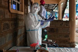 A health worker dressed in personal protective equipment (PPE) prepares to test someone during a mass testing for COVID-19 coronavirus provided free of charge by the Kenyan government in the Kibera slum in Nairobi.