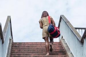 A Black woman walking through London