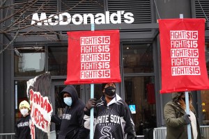 Workers in front of a McDonald's with Fight for $15 signs.