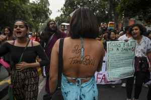 A member and supporter of the lesbian, gay, bisexual, transgender (LGBT) displays a message written on the back against the Transgender Persons (Protection of Rights) Bill while taking part in a pride parade in New Delhi on November 24, 2019.