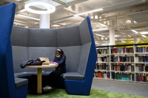 An international student reading in the library at Coventry University​.