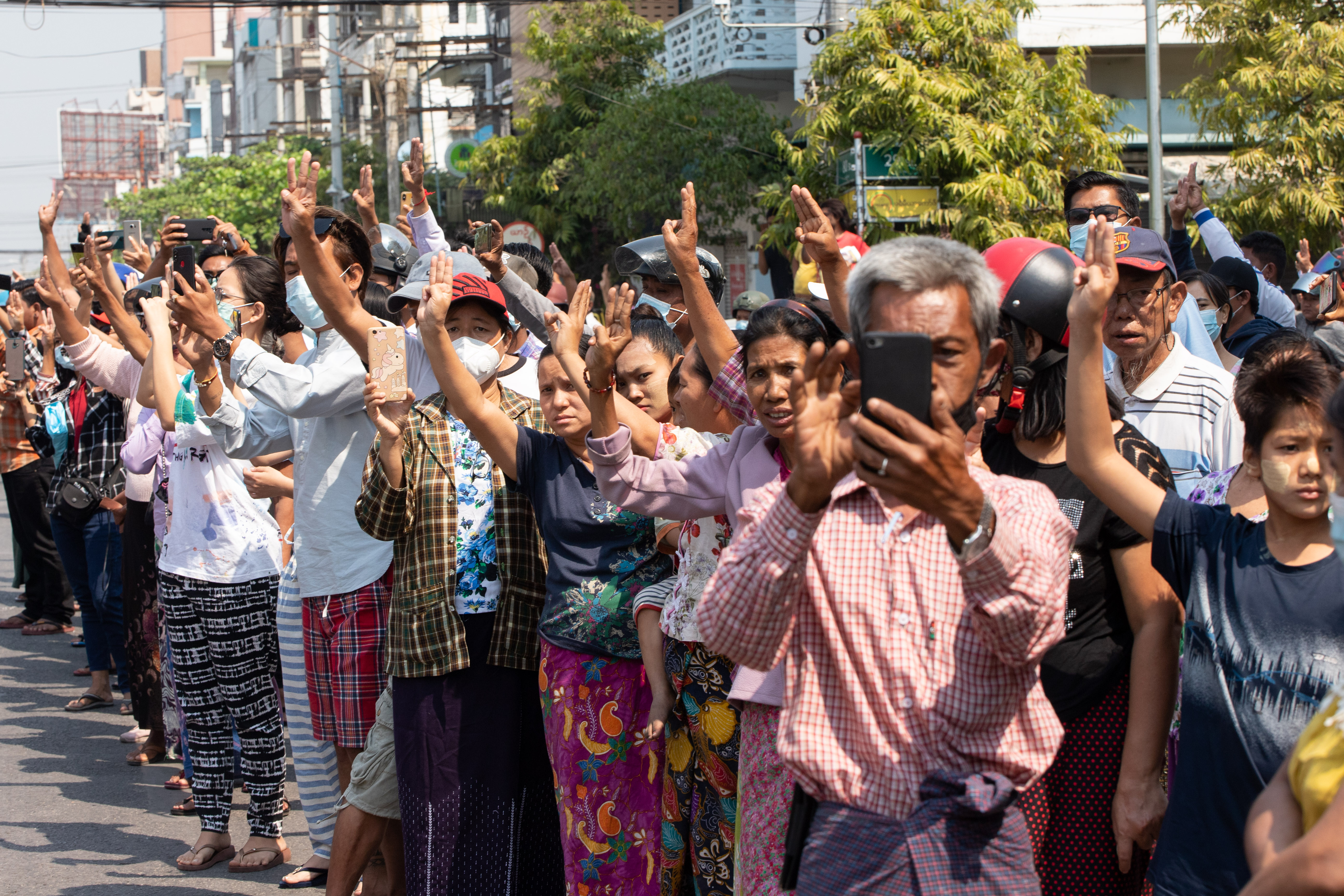 Crowds of supporters flash the three finger salute as a tribute to young protester Angel. PHOTO: STRINGER