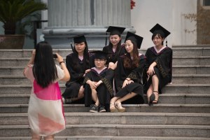 Chinese men put up sexist banners before women