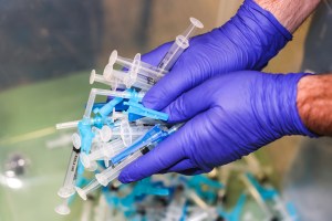 A member of the Thornton Fire Department distributes prepared doses of the Johnson & Johnson COVID-19 vaccine, the newest vaccine approved by the U.S. FDA for emergency use, at an event put on by the Thornton Fire Department on March 6, 2021 in Thornton,