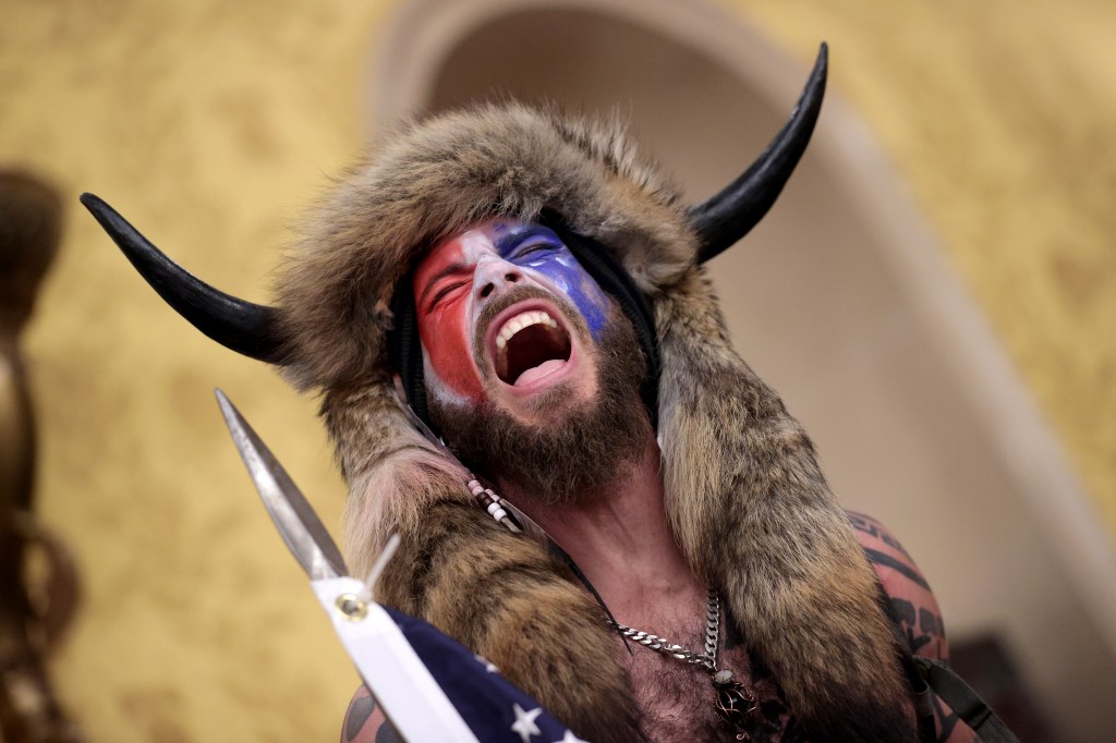 A protester screams "Freedom" inside the Senate chamber after the U.S. Capitol was breached by a mob during a joint session of Congress on January 06, 2021 in Washington, DC.