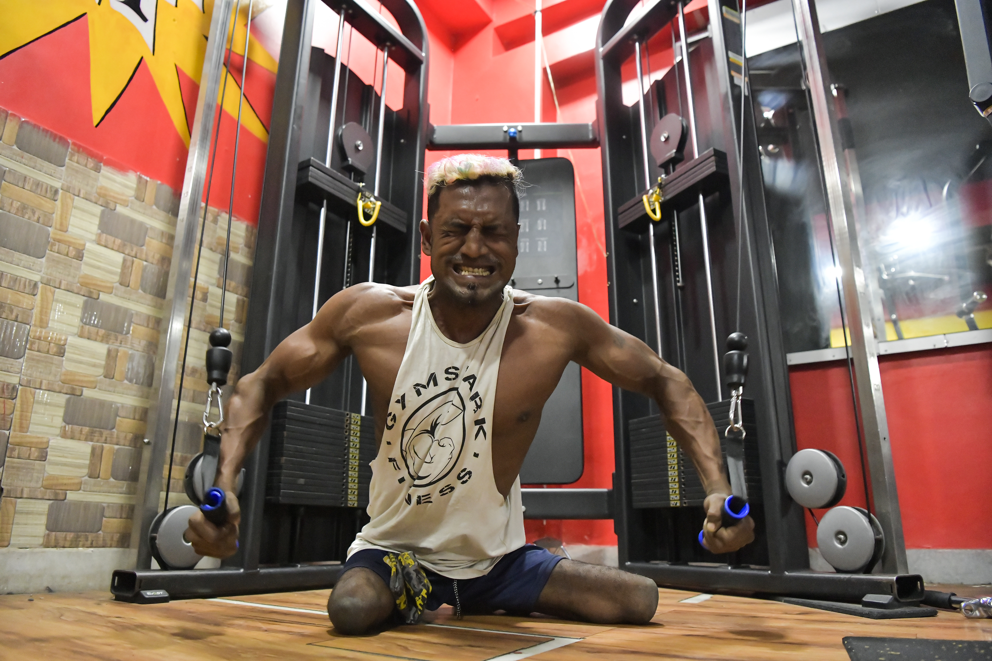 A disabled bodybuilder works out at the gym