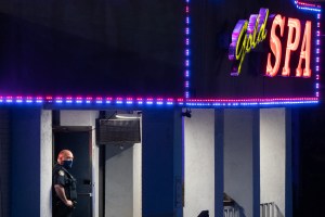 Police officers are seen outside a massage parlor where three people were shot and killed on March 16, 2021, in Atlanta, Georgia.