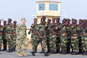 Senegal's Army General Amadou Kane (C) and US Army General Donald Bolduc (L) review the troops during the inauguration of a military base in Senegal.