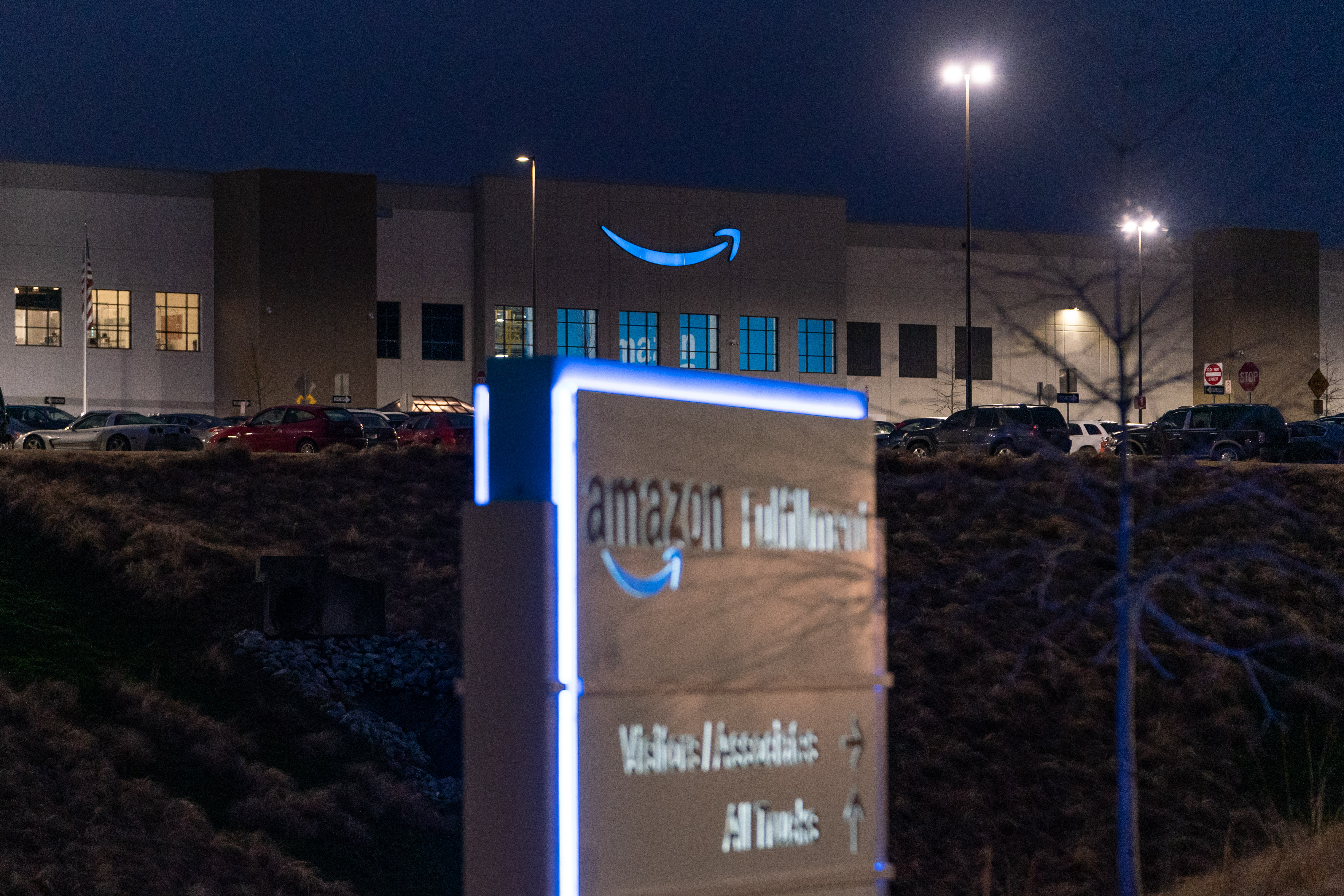 Signage outside the Amazon.com Inc. BHM1 Fulfillment Center at night in Bessemer, Alabama in February. (Elijah Nouvelage/Bloomberg via Getty Images)